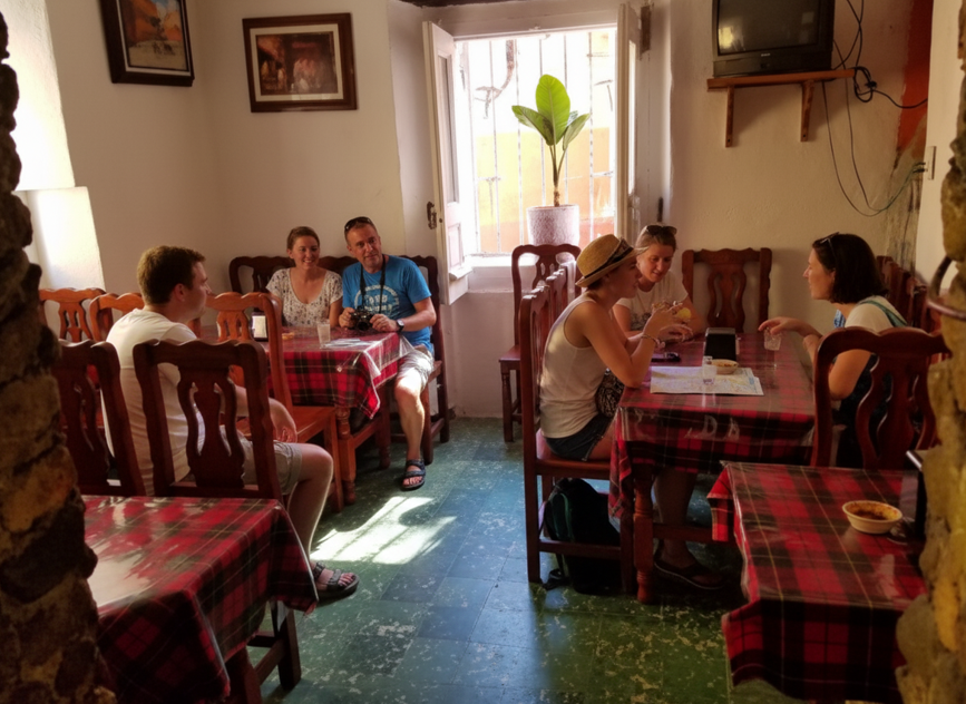 Casual and cozy interior of a traditional Mexican restaurant with wooden furniture and plaid tablecloths. A budget-friendly place to eat in Guanajuato.